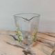 Orangeade service with a jug and six glasses featuring a daisy pattern.