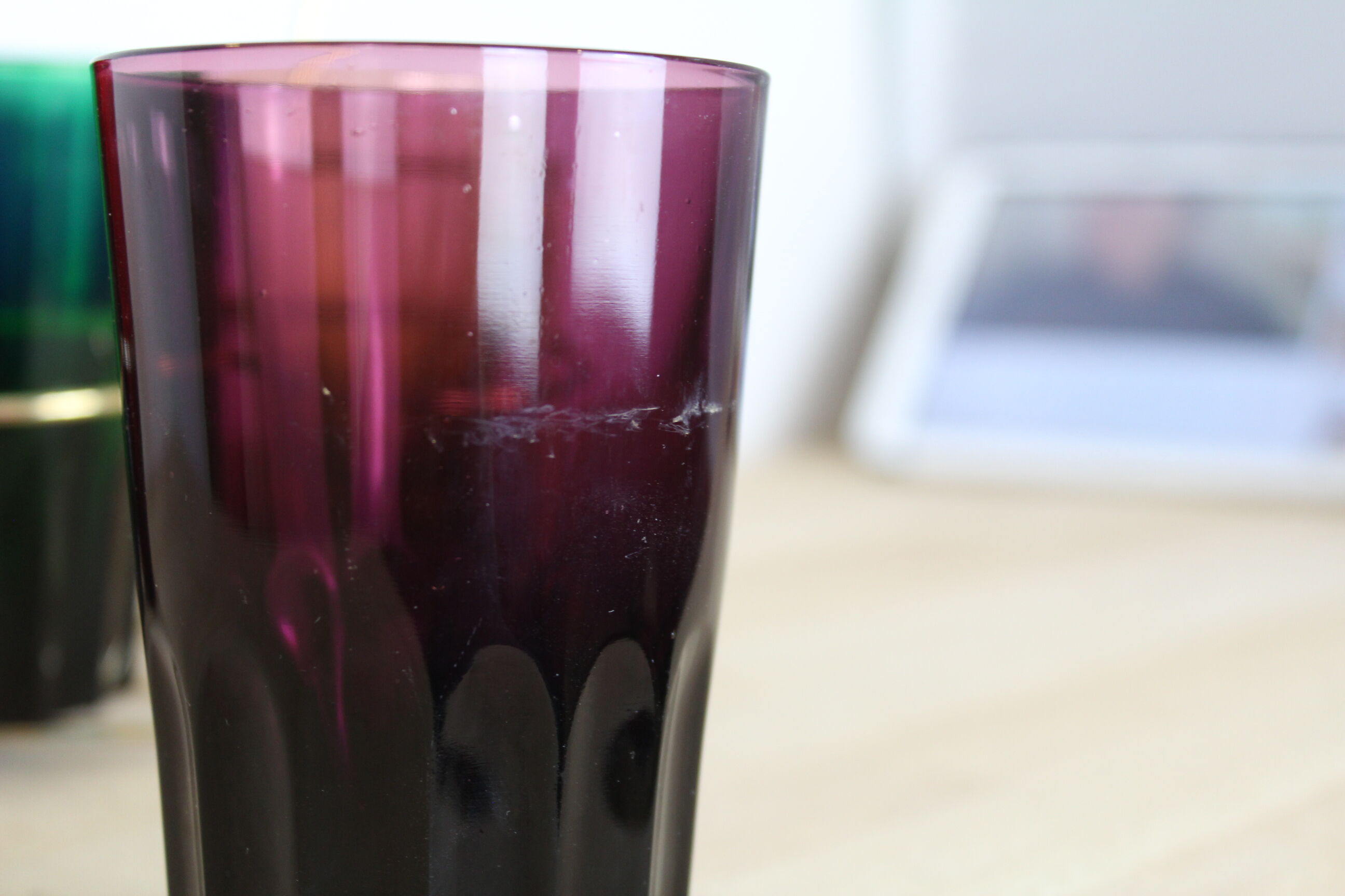 Set of 6 coloured glasses in their brass holder, basket