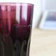 Set of 6 coloured glasses in their brass holder, basket