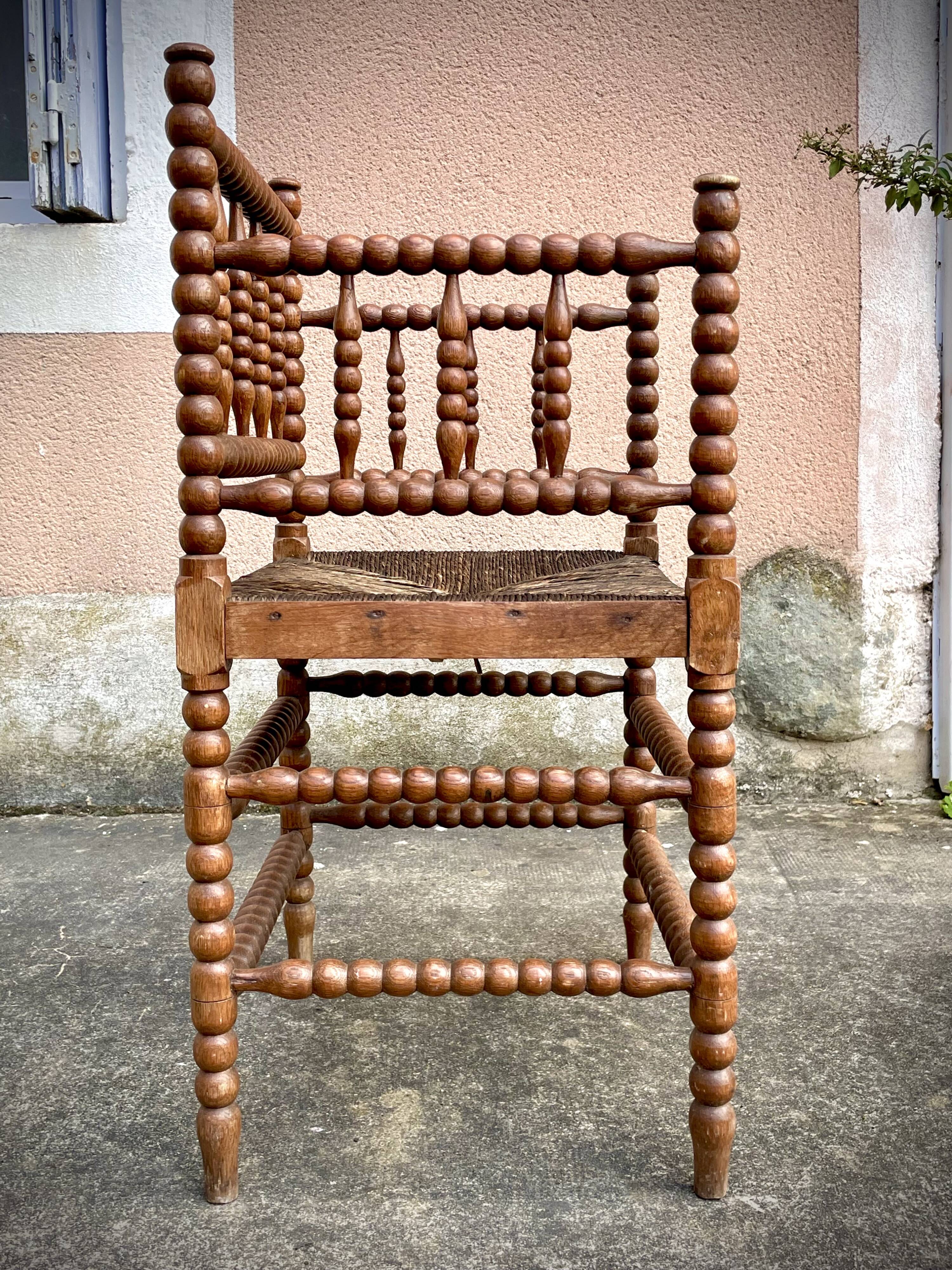 Antique Bobbin armchair with straw seat
