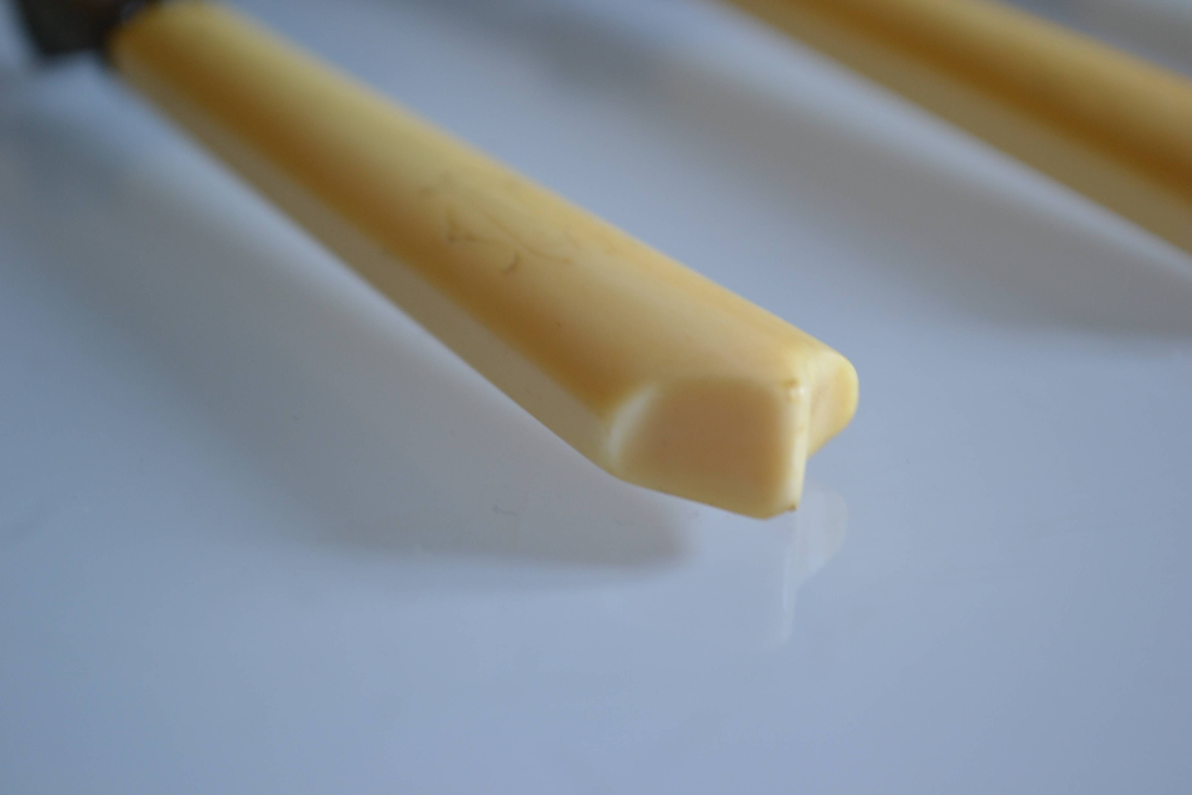 11 antique dessert knives from the 19th century with ivory-colored handles and a monogram