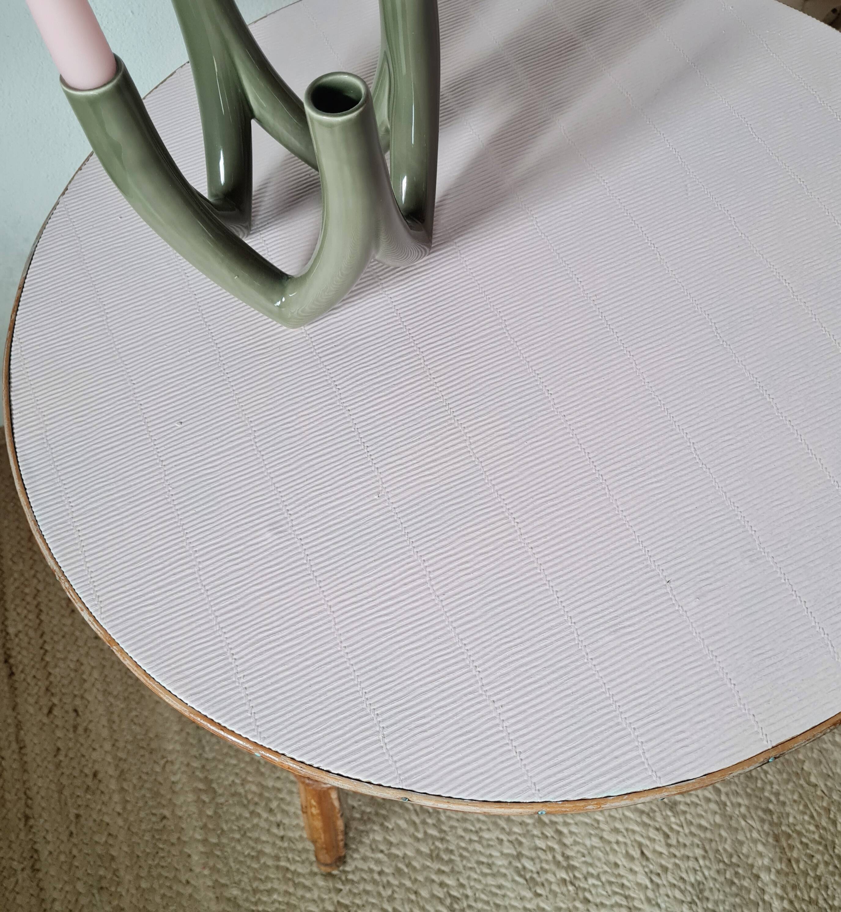 Round soft pink rattan table