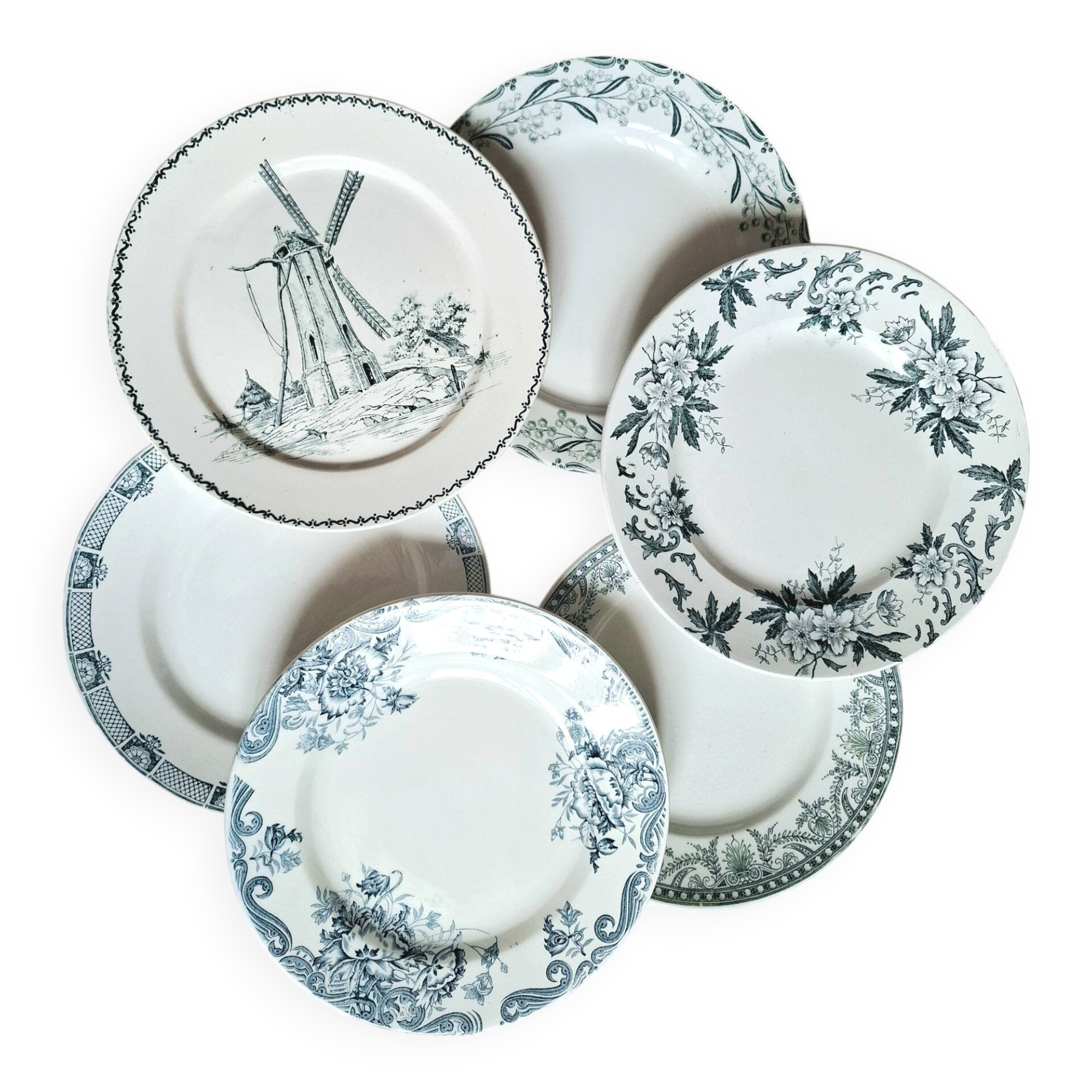 Old mismatched flat plates made of ironstone earthenware.