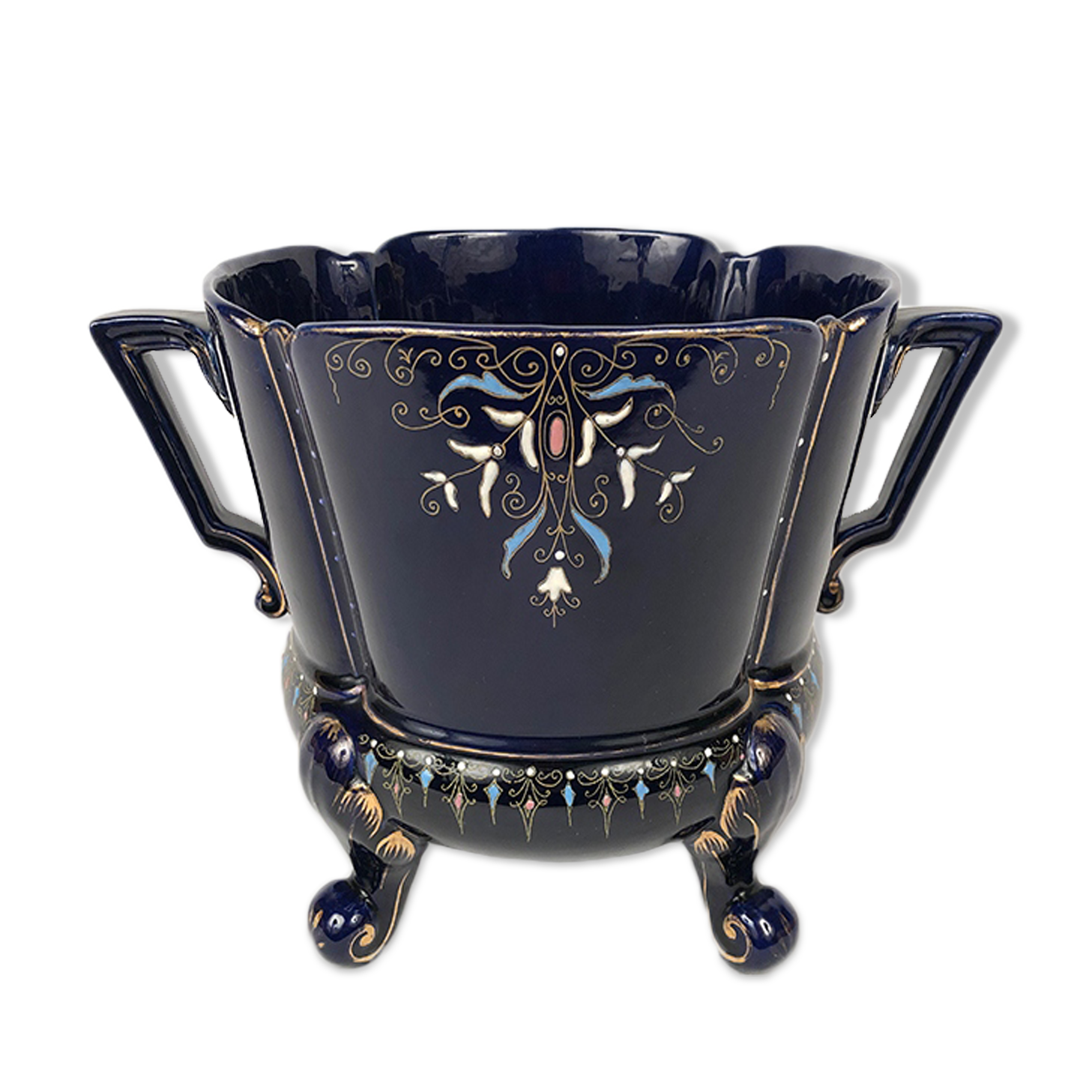 Large earthenware pot cover with enamelled decoration on a blue oven background