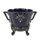 Large earthenware pot cover with enamelled decoration on a blue oven background