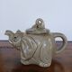 vintage ceramic teapot in the shape of a grey elephant