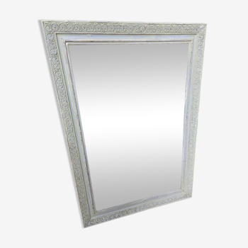 Old mirror with light green contours with mauve shades