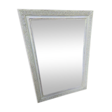 Old mirror with light green contours with mauve shades