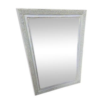 Old mirror with light green contours with mauve shades