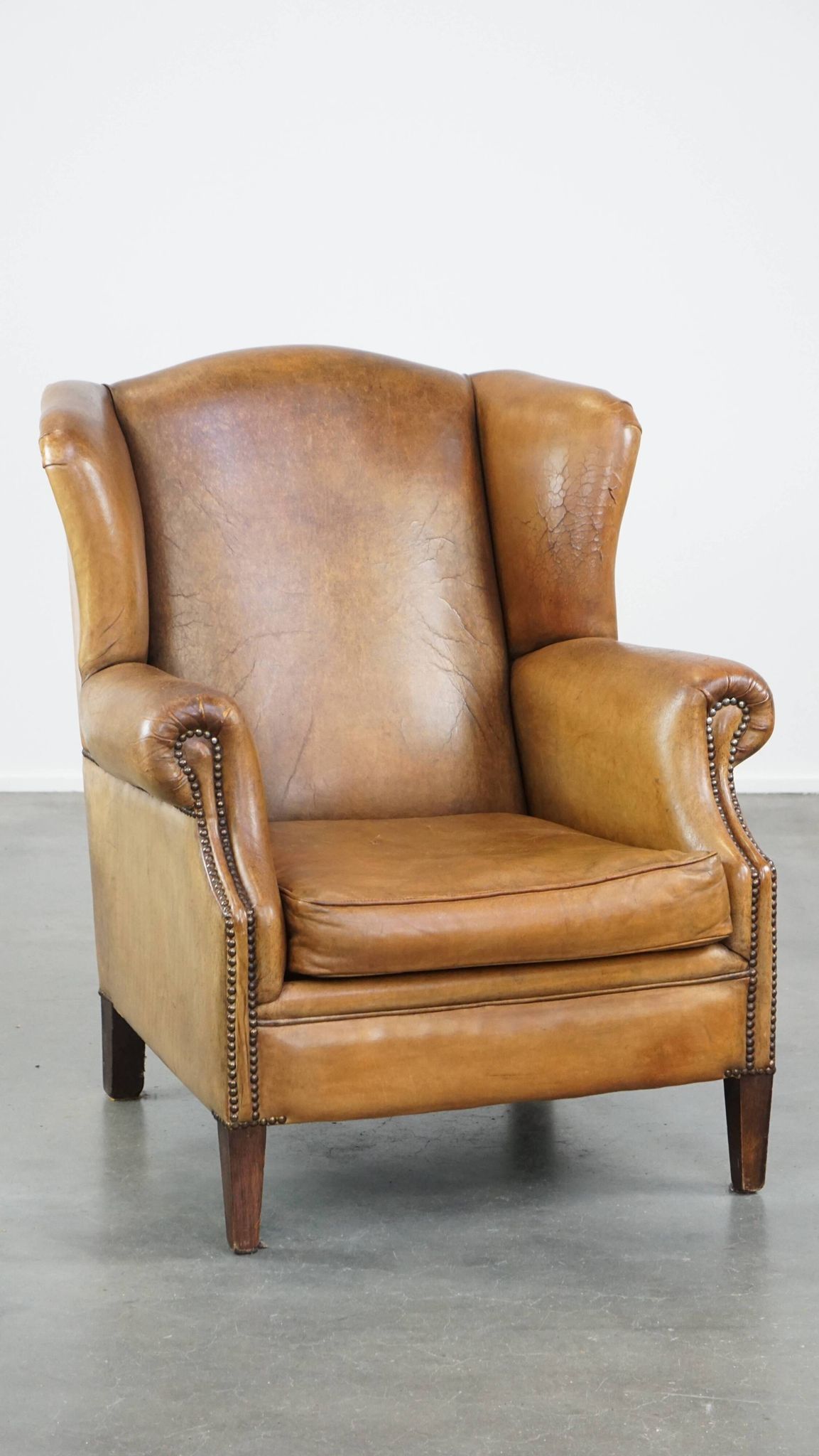 Patinated sheep leather wingback armchair