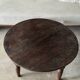 Coffee table, round antique Indonesian teak table with straight legs.