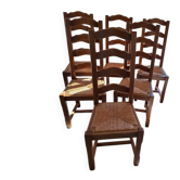 Set of 6 solid oak chairs with straw seats.