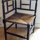 Corner chair made of turned wood with a straw seat.