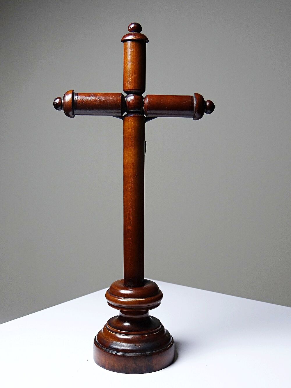 Antique wooden altar crucifix with a turned design and silver-plated Christ.