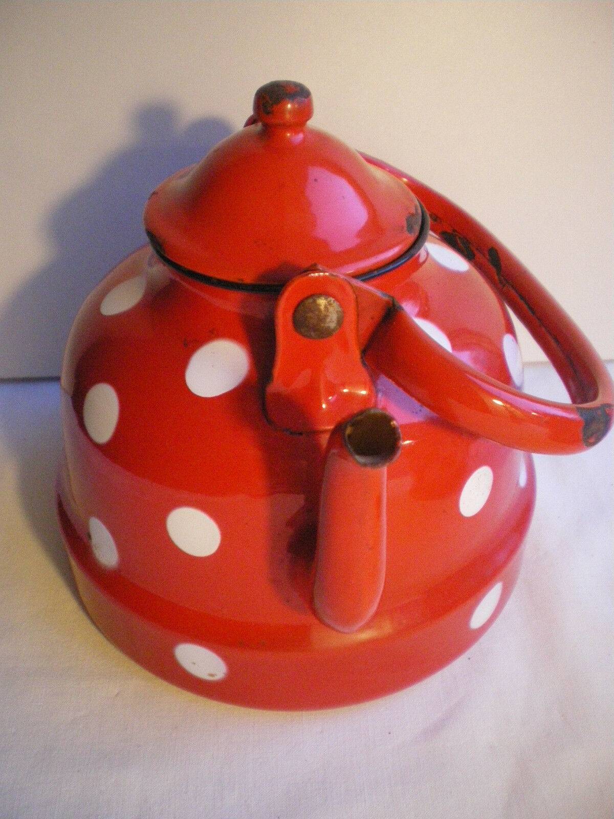 Vintage kettle in red enamelled sheet with white polka dots