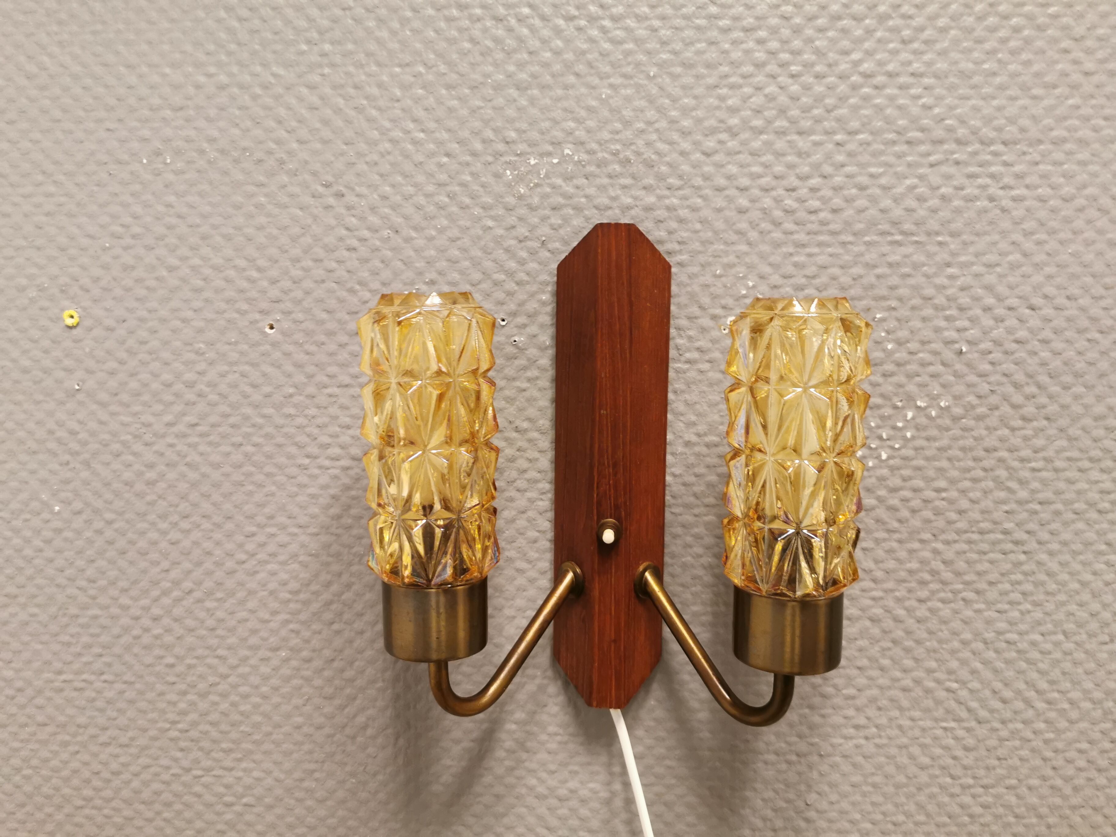 Older Danish wall lamp, with double light source, made of teak wood, amber colored glass and brass