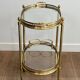 Small oval rolling table in brass with double removable trays from Maison Bagués.