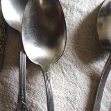 A set of 6 silver-plated metal soup spoons with foliage design.
