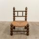 Low chair in beaded wood and straw