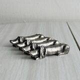 Antique metal knife rest in the shape of a dog.