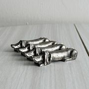 Antique metal knife rest in the shape of a dog.