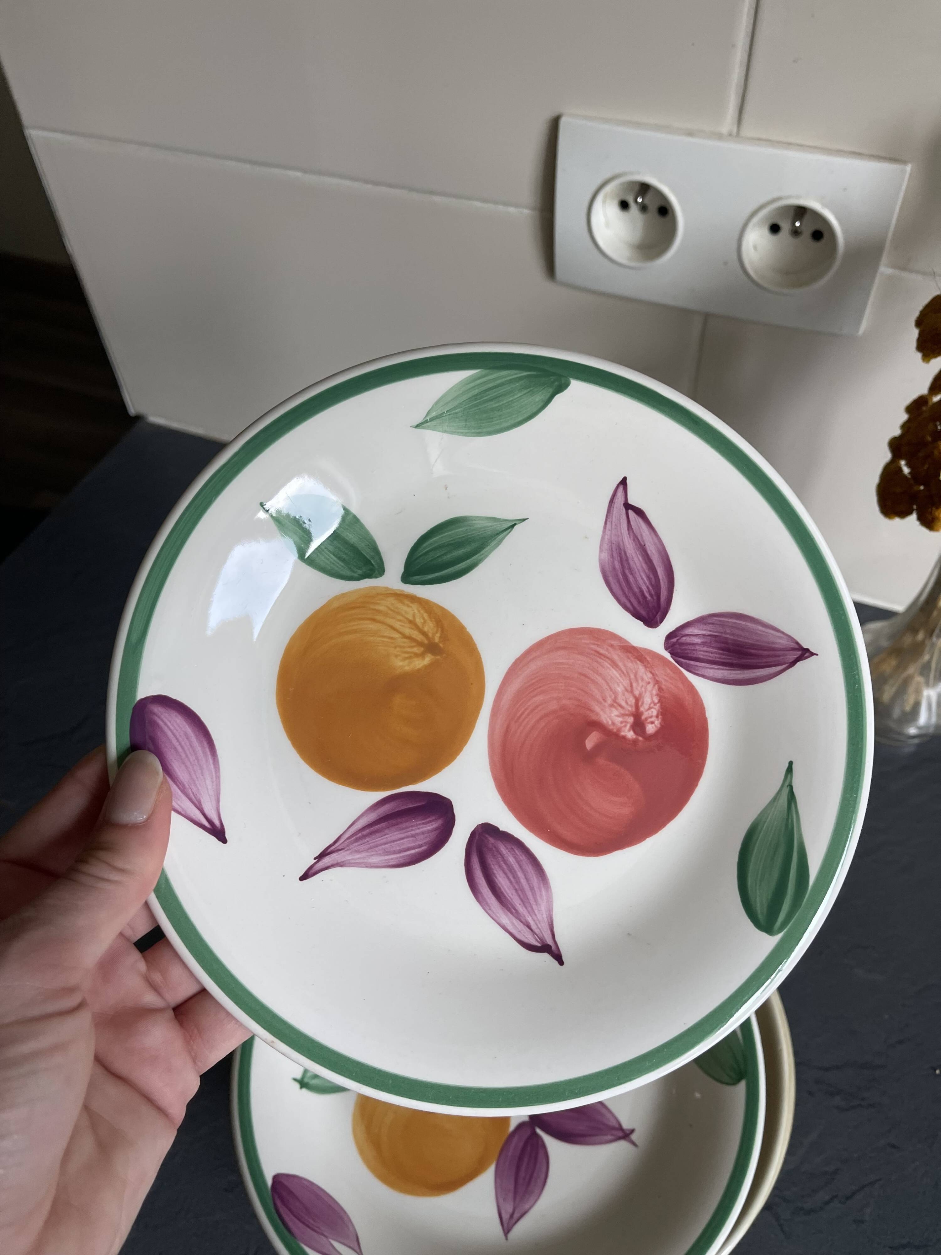 Italian ceramic plates with floral fruit designs.
