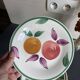 Italian ceramic plates with floral fruit designs.