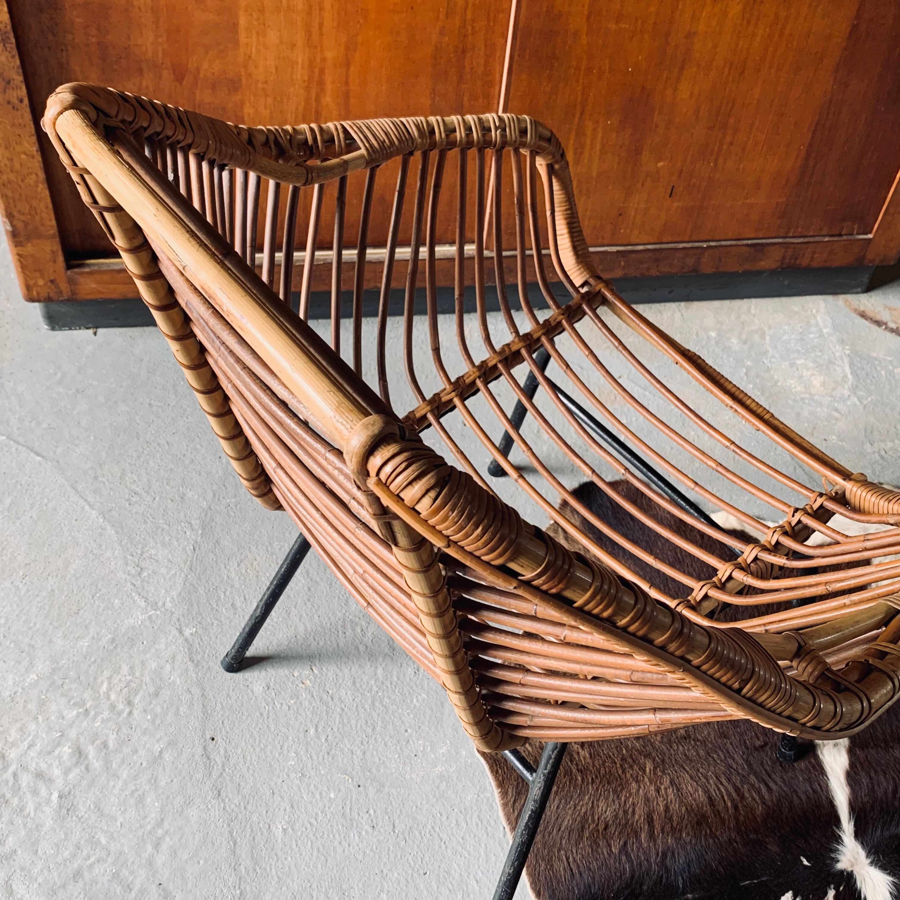 Rattan armchair and black metal base 1960