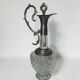 Vintage glass decanter with cut design and silver-plated metal, stopper included.