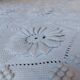 White bed throw with relief embroidery and floral patterns