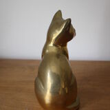Cat sitting in brass