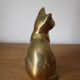 Cat sitting in brass
