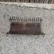 Vintage cast iron fireplace cradle with 16 bars.