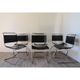 Series of 6 minimalist chairs in chrome metal and black leather around 1970