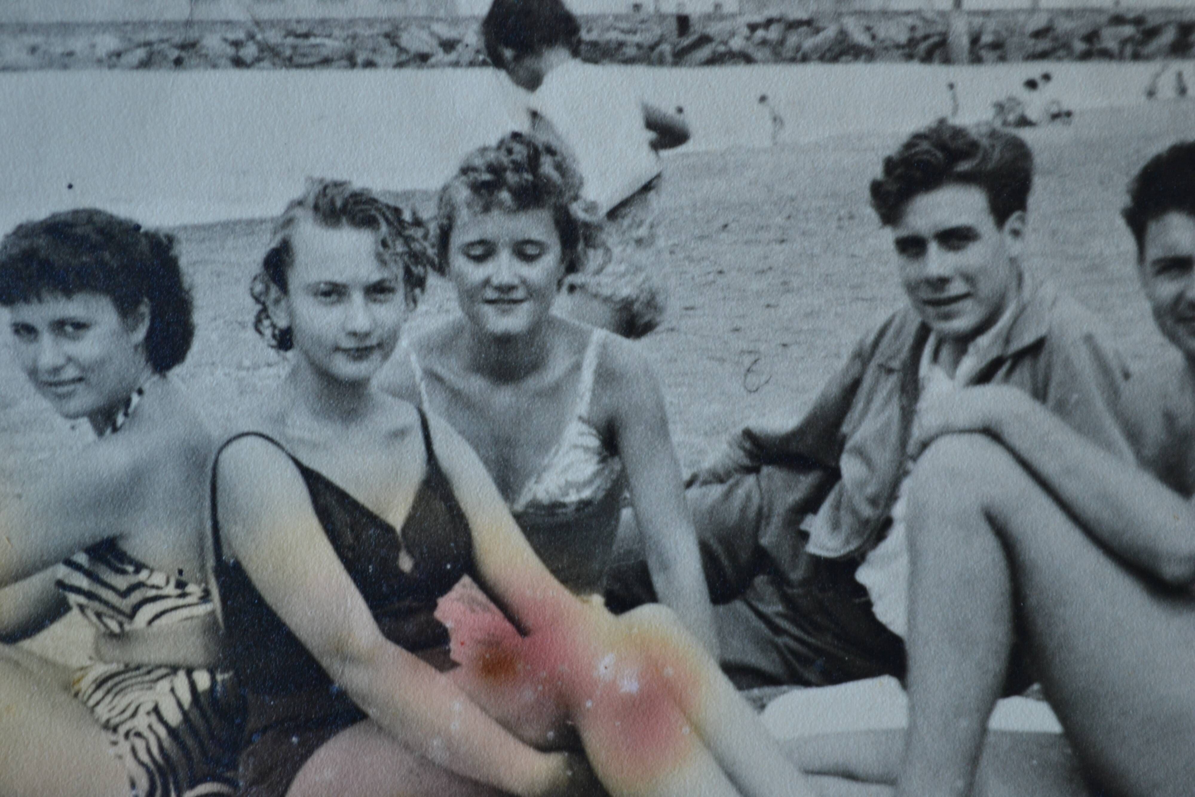 Old film photo circa 1950 the beach group of teenagers