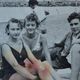 Old film photo circa 1950 the beach group of teenagers