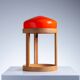 Bent oak wood table lamp with orange glass shade