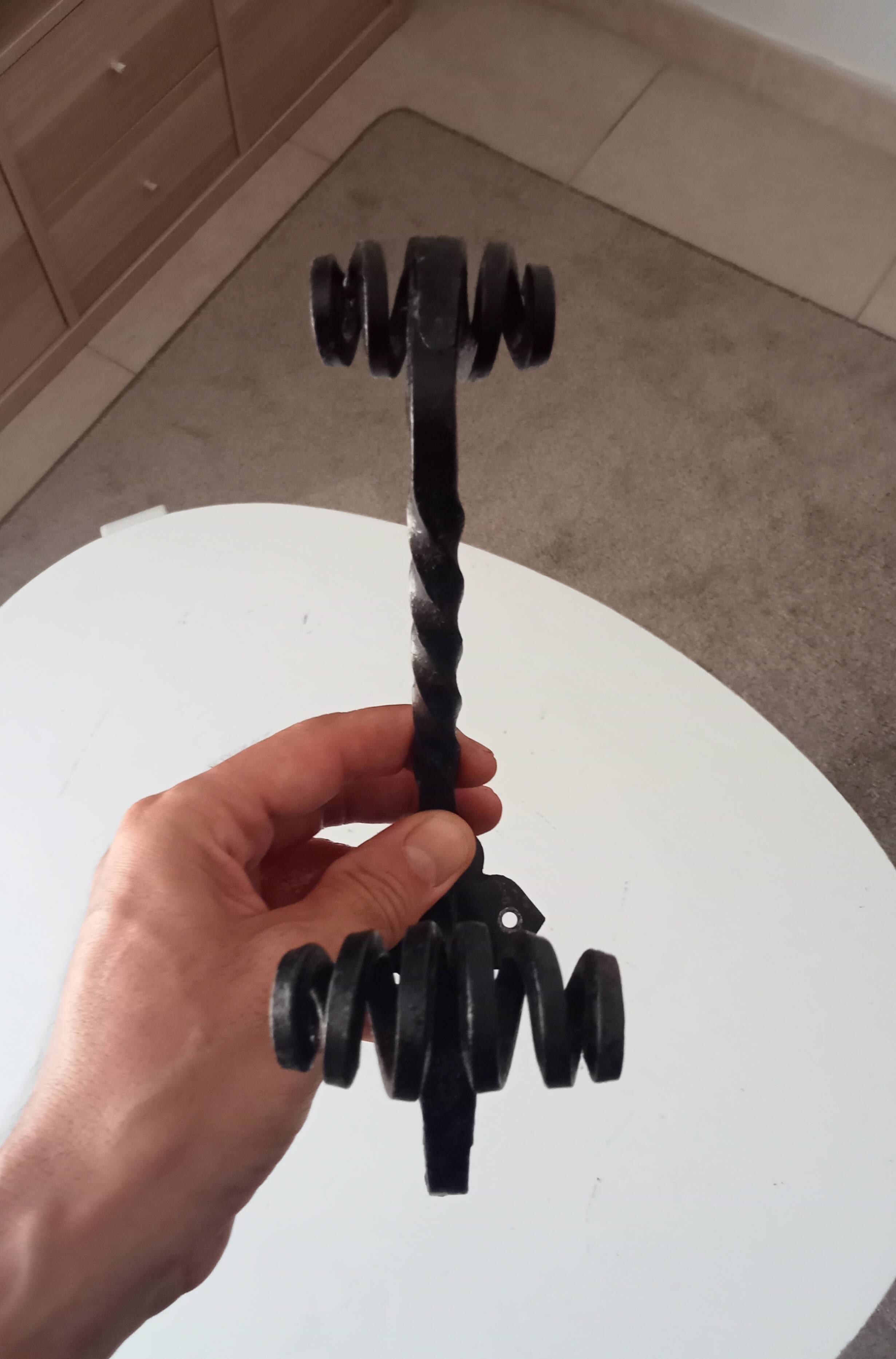 Brutalist wall coat rack in wrought iron.