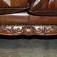 Chesterfield leather canapé with claw and ball feet by Howard & Son, Victorian era.