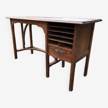 Old oak desk with curved wooden sleepers in the Art Nouveau spirit of the early 20th century.