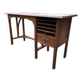 Old oak desk with curved wooden sleepers in the Art Nouveau spirit of the early 20th century.