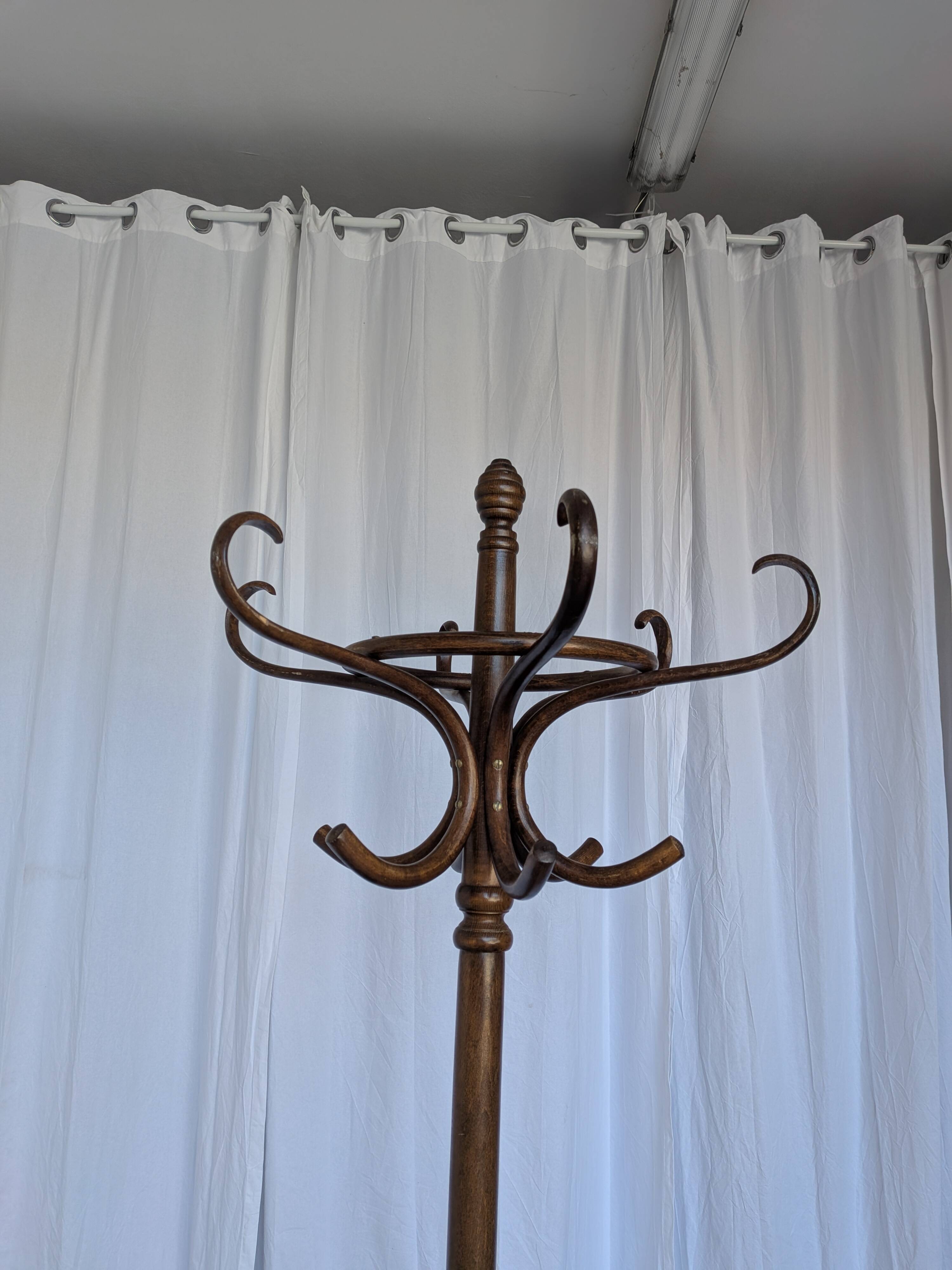 Vintage bentwood coat rack in Thonet style / Dark wood coat rack with shadow.