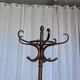 Vintage bentwood coat rack in Thonet style / Dark wood coat rack with shadow.