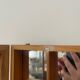 Storage box with wall-mounted glass mirror with integrated storage