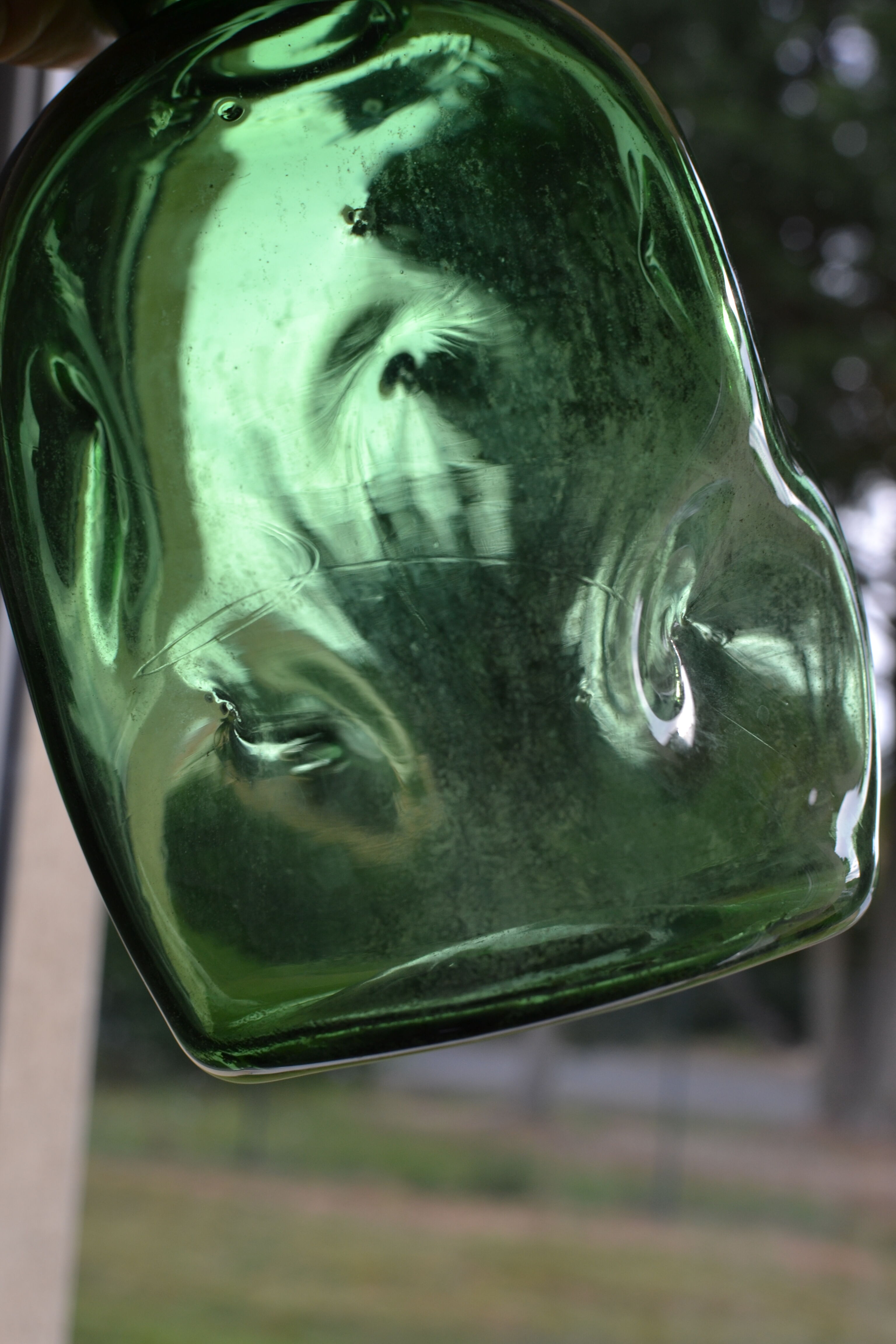 Dented green bottle