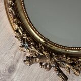 19th century oval gilded mirror, torch & quiver 106cm
