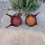 pair of round wooden chairs with a pattern on the seat