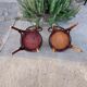 pair of round wooden chairs with a pattern on the seat
