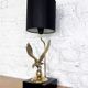 Brass lamp on black lacquered wooden base