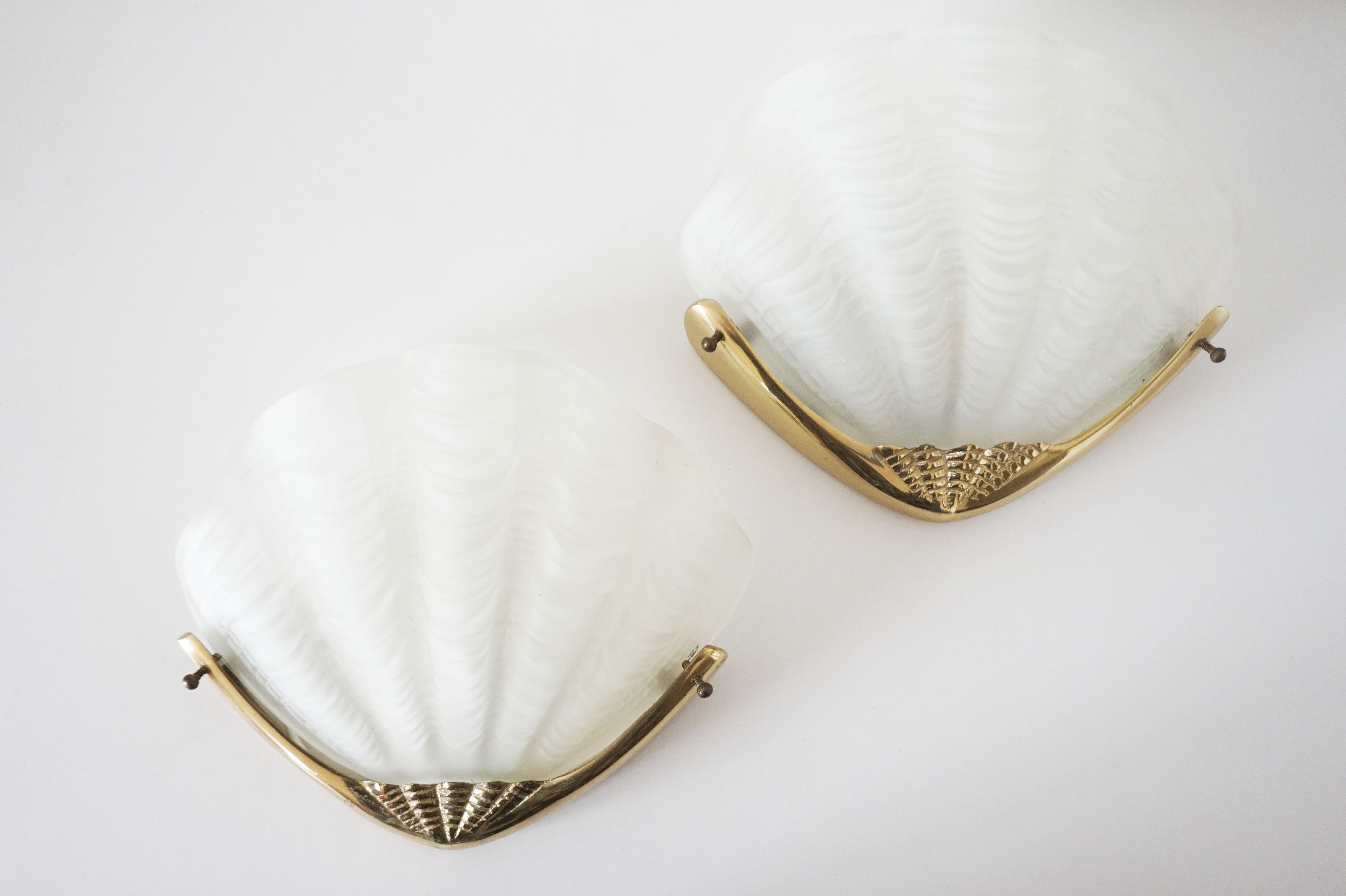 Pair of glass and gold metal shell sconces